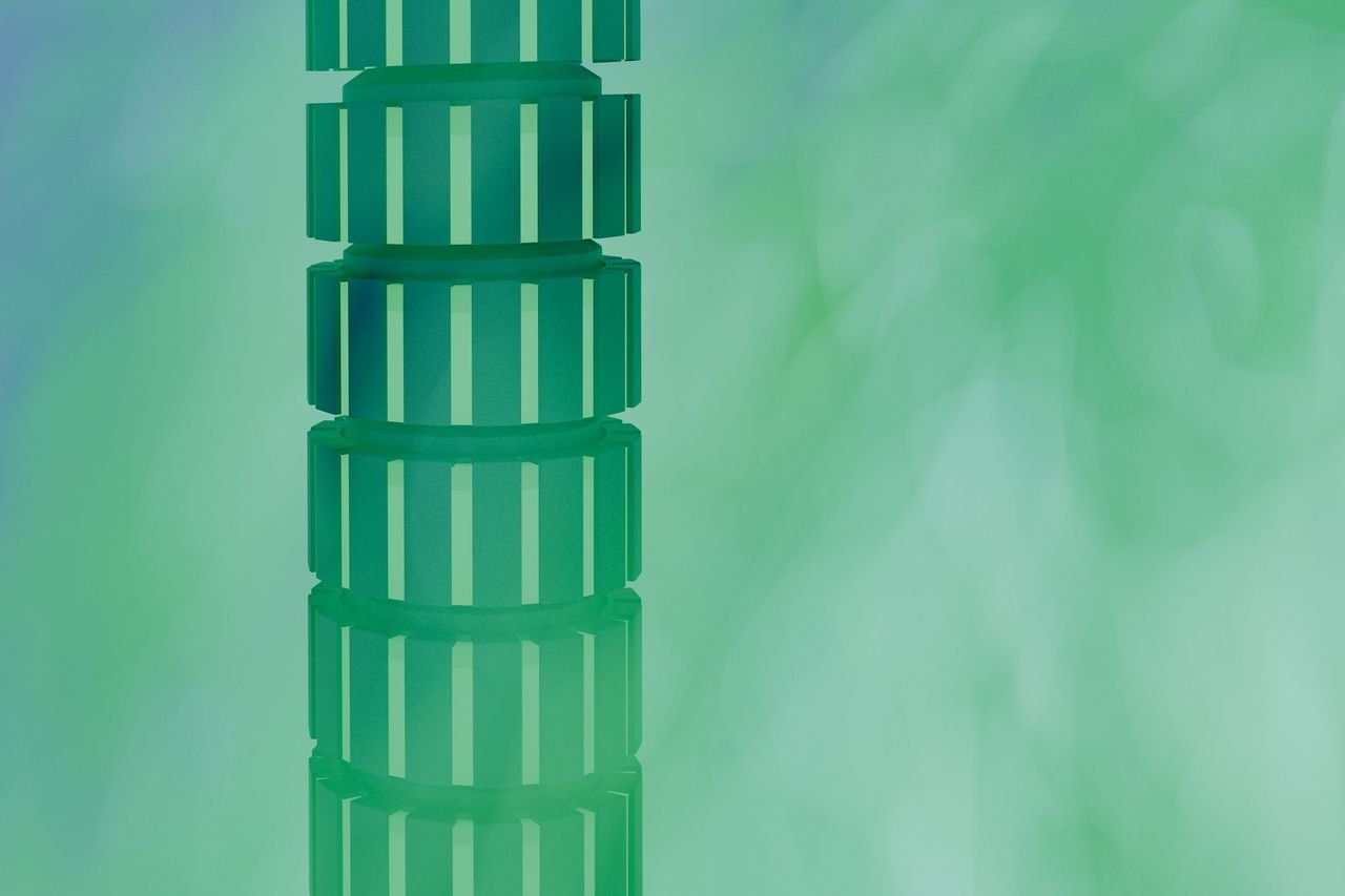 about-img Abstract 3D rendering of a vertical green geometric pattern on a textured background.